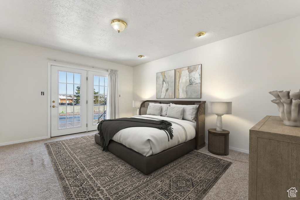 Bedroom with carpet floors, access to outside, baseboards, and a textured ceiling