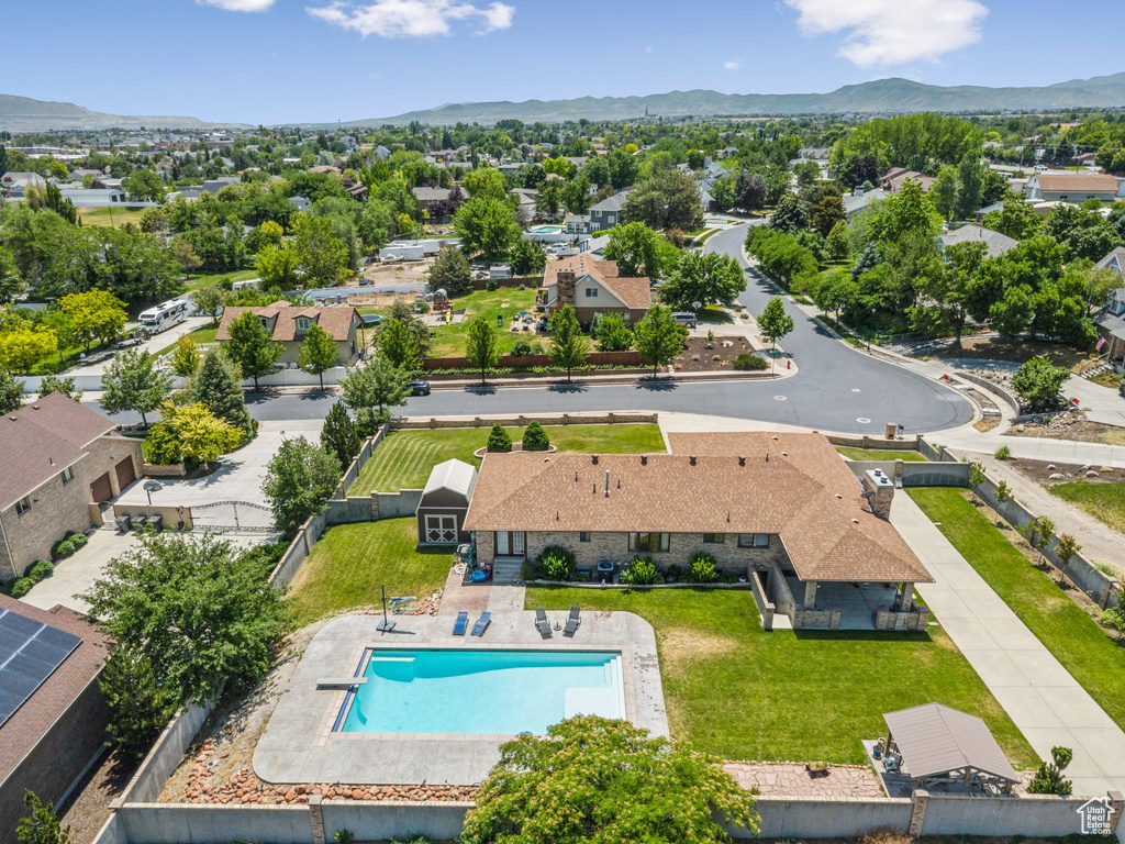 Aerial perspective of suburban area featuring mountains and a pool