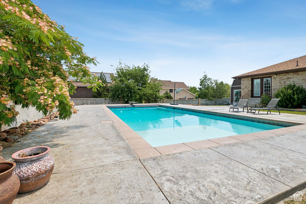 View of pool featuring a patio area and a fenced backyard