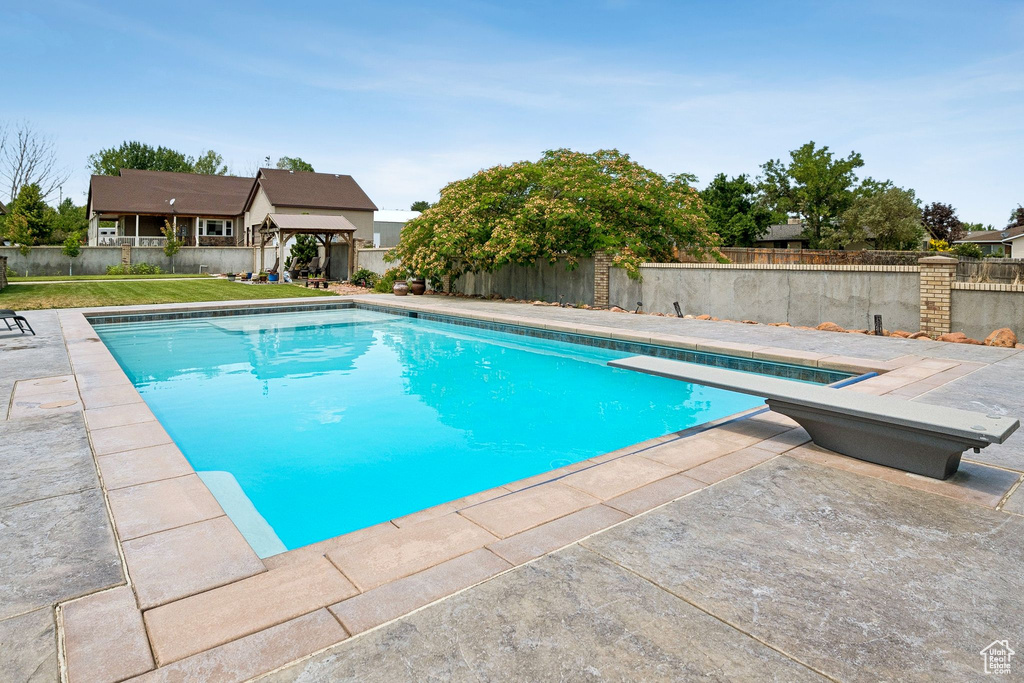 View of swimming pool featuring a fenced backyard, a patio, and a gazebo