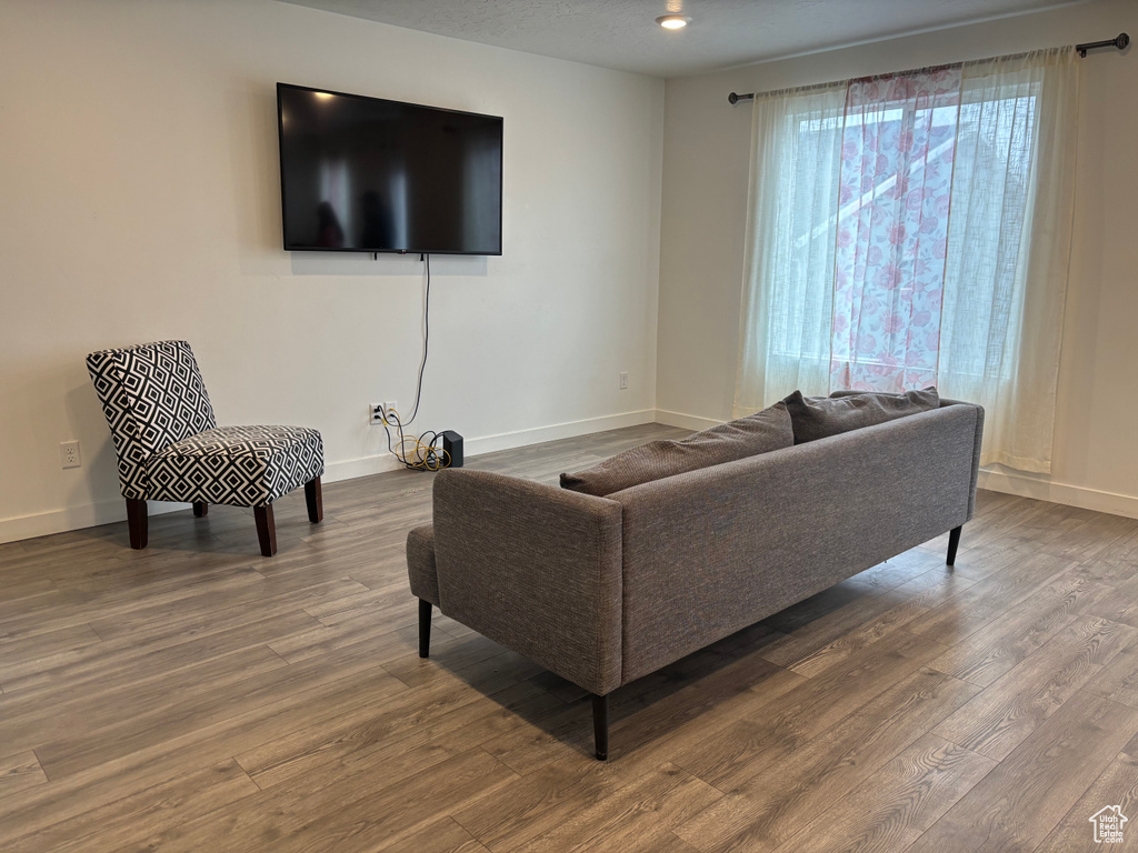 Living area with baseboards and wood finished floors