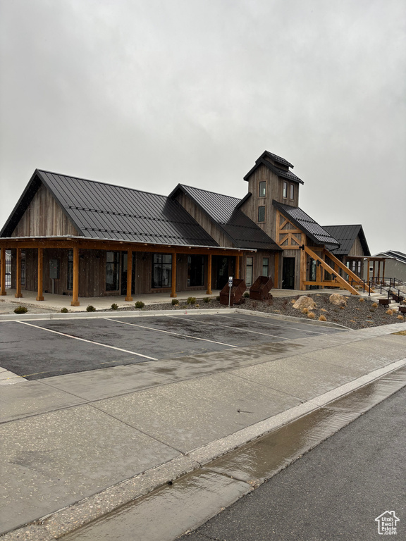 View of building exterior featuring uncovered parking