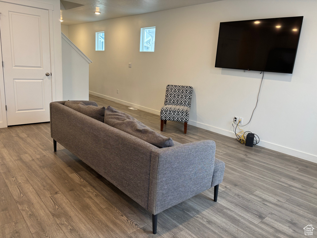 Living area featuring stairway, wood finished floors, and baseboards