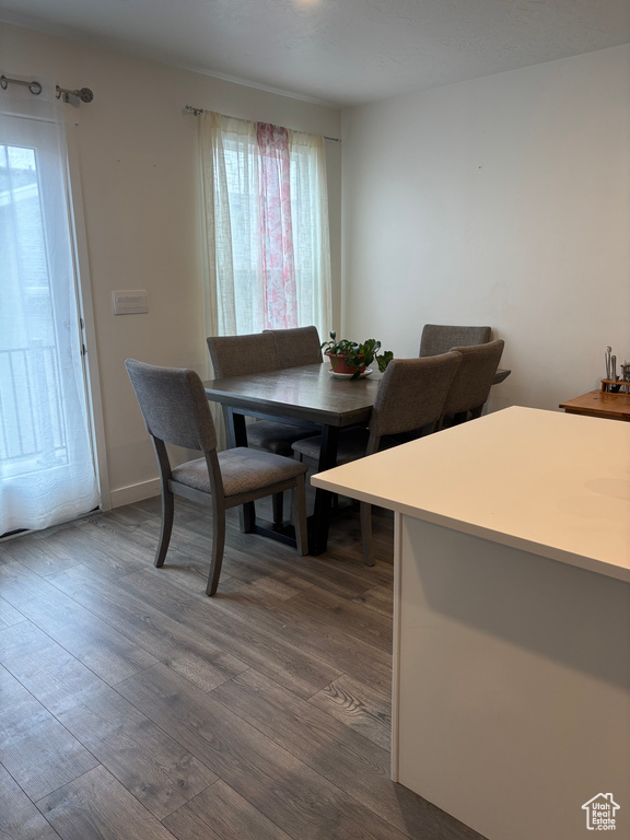 Dining space with dark wood-type flooring