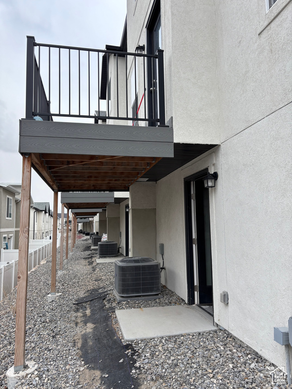 View of patio / terrace featuring cooling unit and fence