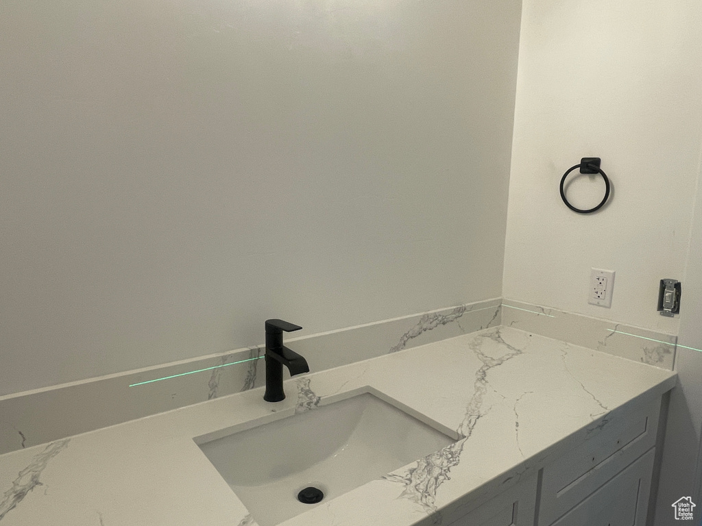 Bathroom with marble finish floor and a sink
