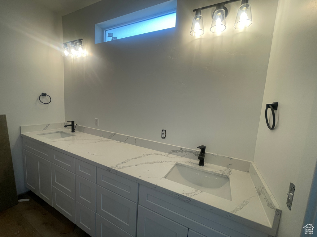 Full bathroom with double vanity and a sink
