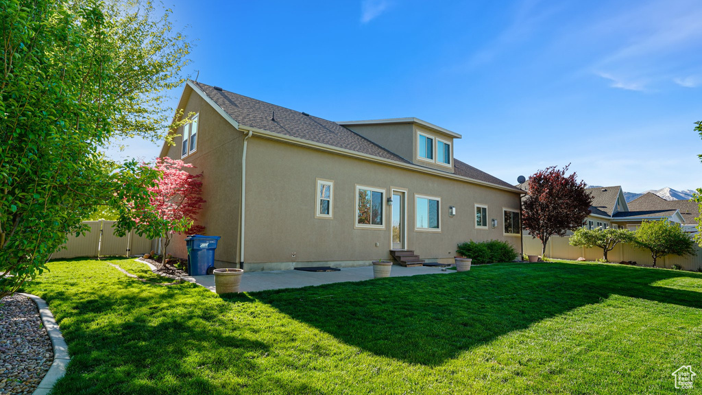 Back of property featuring entry steps, stucco siding, and a patio area
