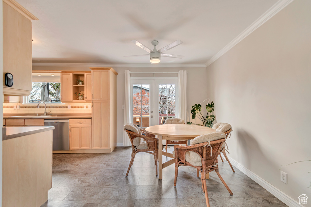 Dining area with french doors, a ceiling fan, baseboards, and ornamental molding