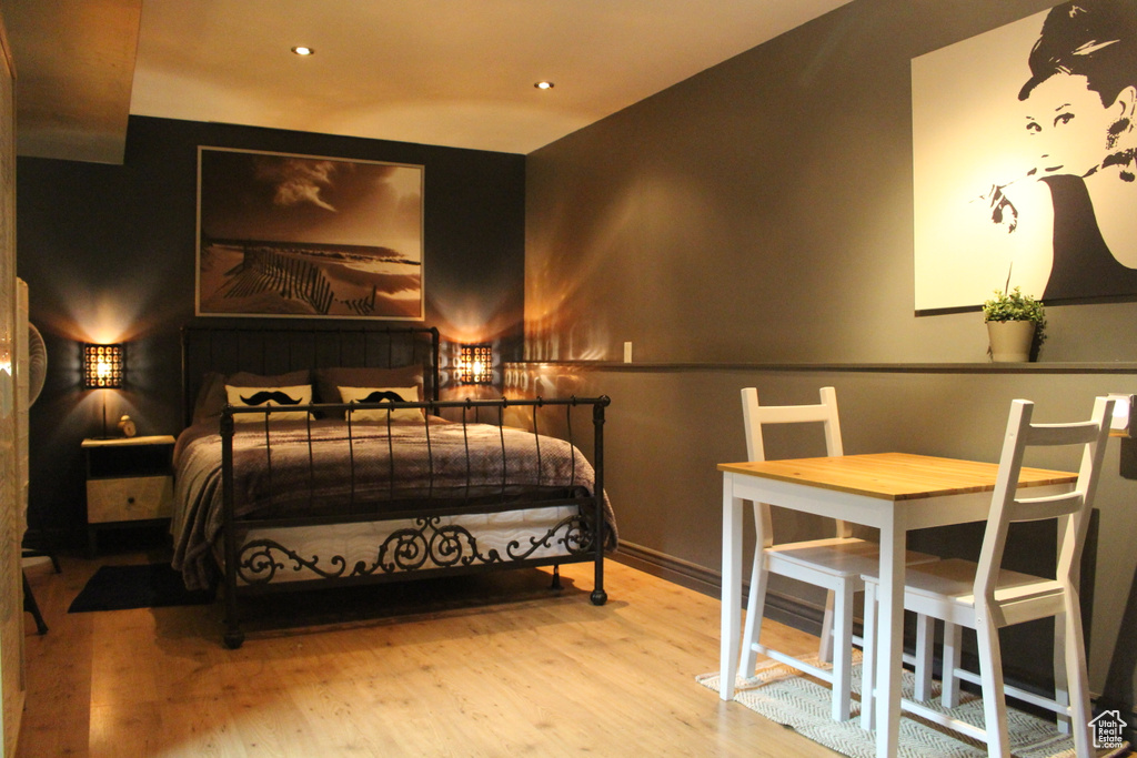 Bedroom with baseboards, recessed lighting, and wood finished floors