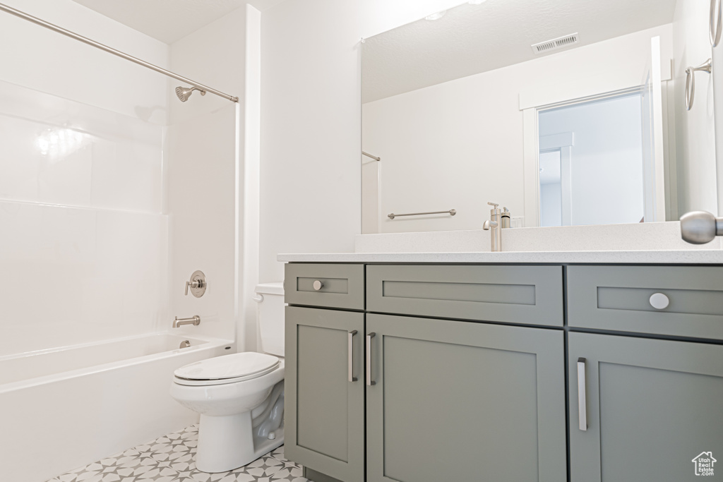Bathroom with vanity, washtub / shower combination, and tile patterned floors