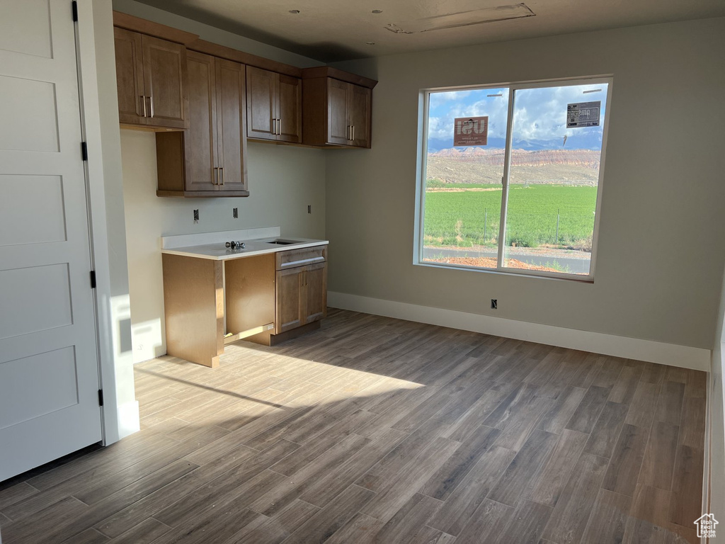 Kitchen featuring wood finished floors and baseboards