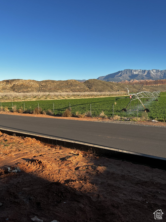 View of asphalt street featuring a mountain view and a view of countryside