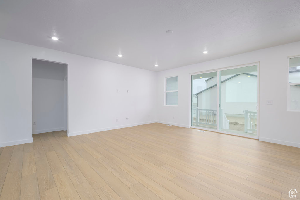 Empty room with recessed lighting, baseboards, and light wood finished floors