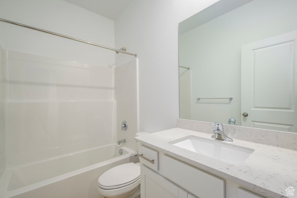 Bathroom featuring vanity, toilet, and shower / tub combination
