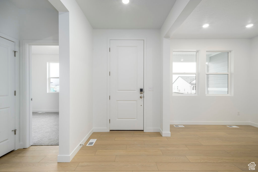 Foyer entrance featuring light wood-style flooring, recessed lighting, baseboards, and visible vents
