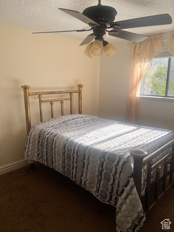 Carpeted bedroom with a ceiling fan