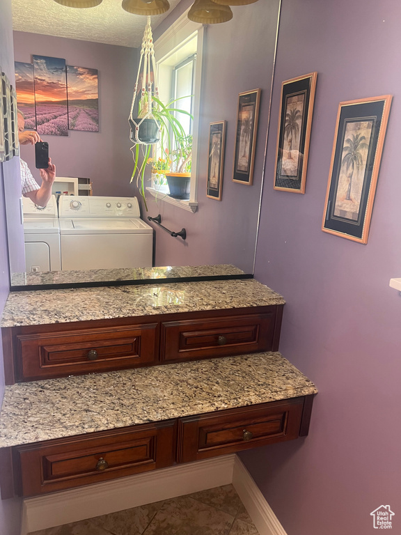Bathroom featuring washer and dryer and tile patterned floors