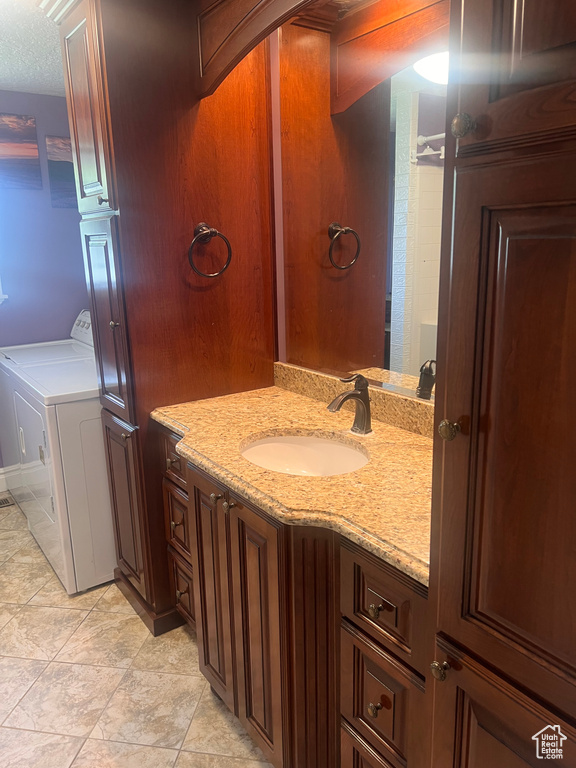 Bathroom featuring vanity and washer / dryer