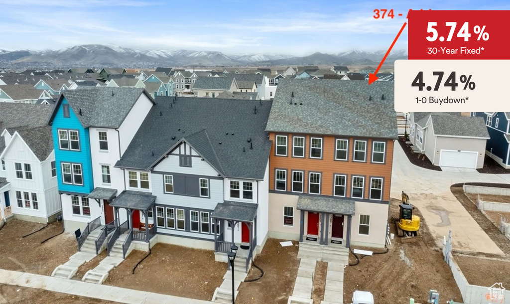 Exterior space with a residential view, roof with shingles, and a mountain view