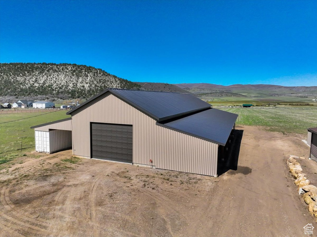 Detached garage with driveway and a mountain view