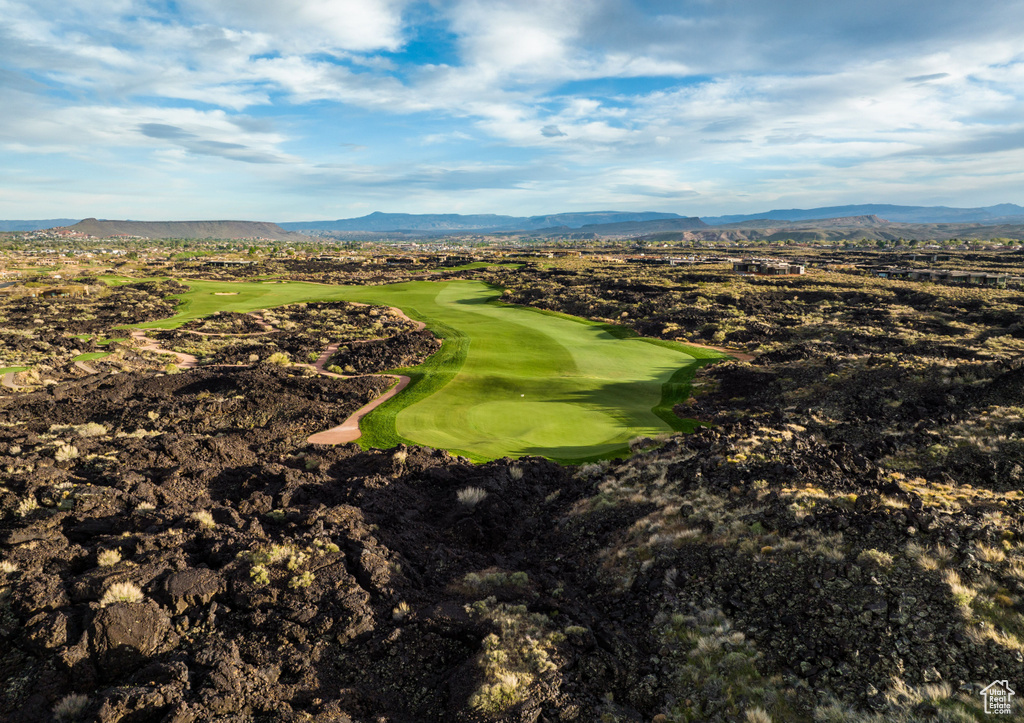 Drone / aerial view of a mountainous background and a local golf course