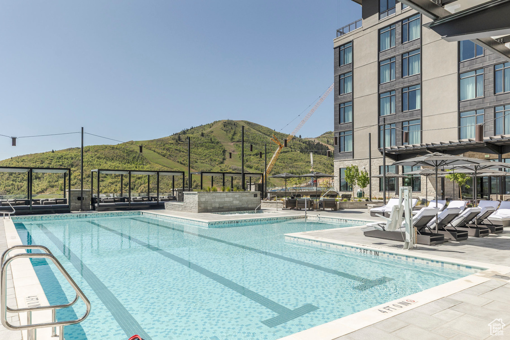 Community pool featuring a mountain view
