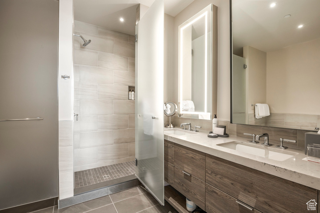 Full bathroom featuring a sink, a stall shower, and tile patterned floors