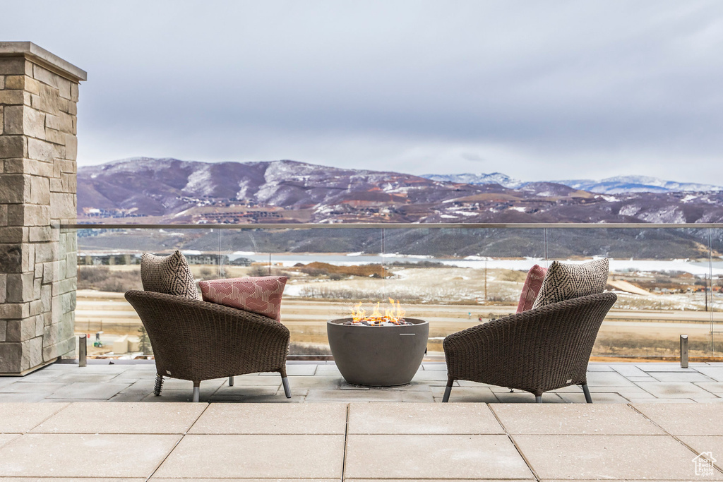 View of patio / terrace with a mountain view and a fire pit
