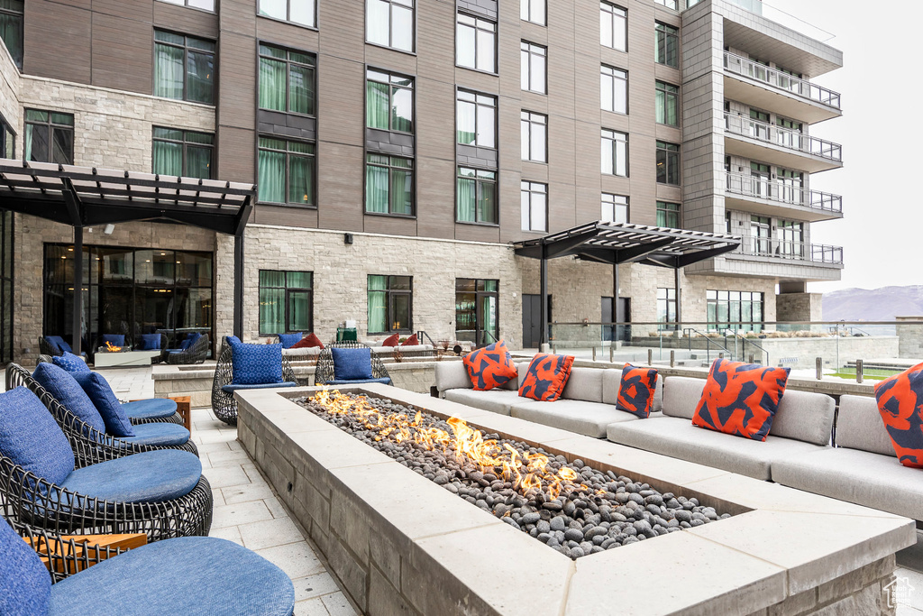 View of patio / terrace with a mountain view and an outdoor living space with a fire pit
