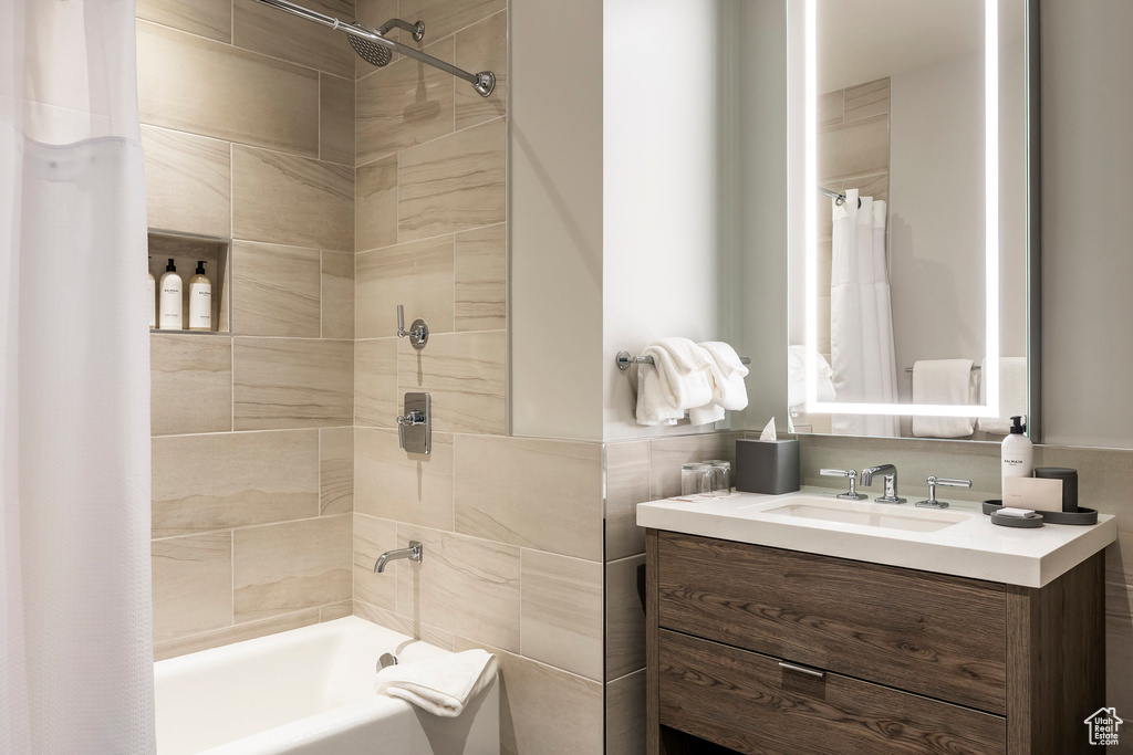 Full bathroom with shower / bathtub combination with curtain and vanity