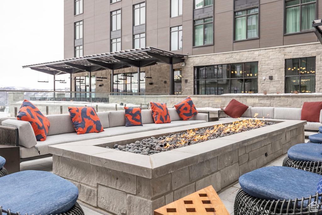View of patio featuring an outdoor living space with a fire pit