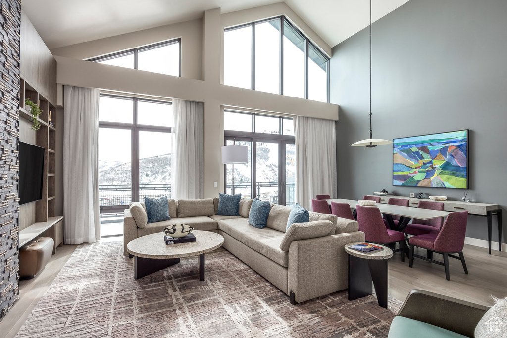 Living area with high vaulted ceiling and wood finished floors