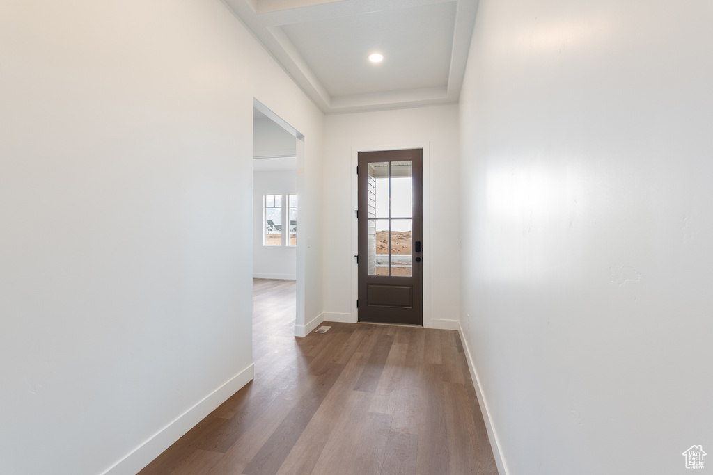 Entryway with recessed lighting, wood finished floors, and baseboards