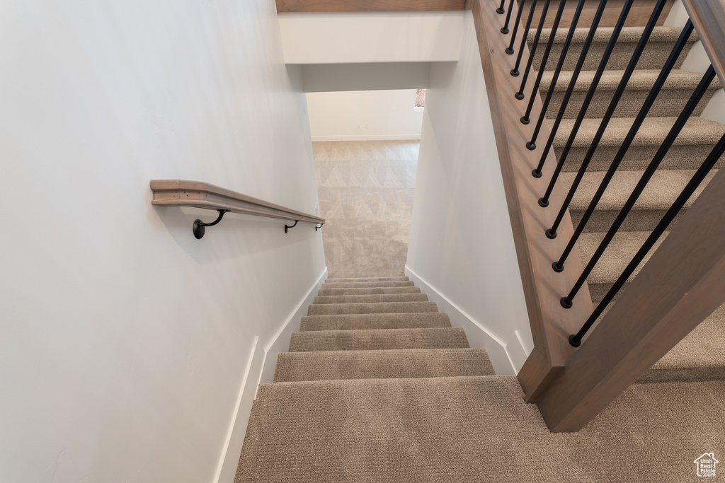 Stairway featuring carpet flooring and baseboards