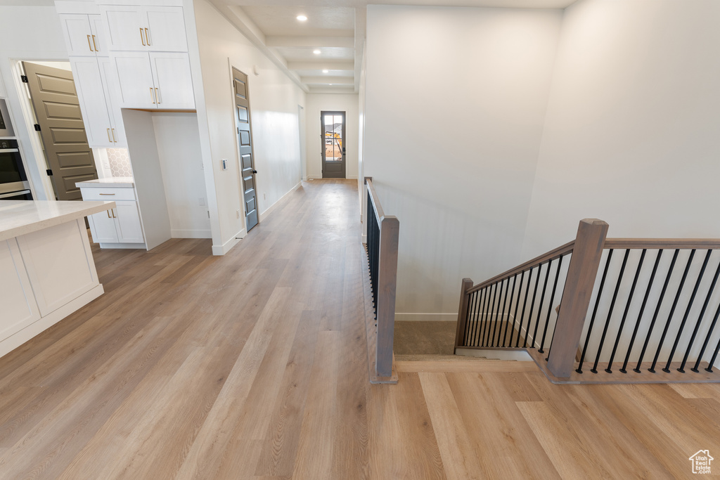 Hallway featuring recessed lighting, an upstairs landing, light wood-style floors, and baseboards
