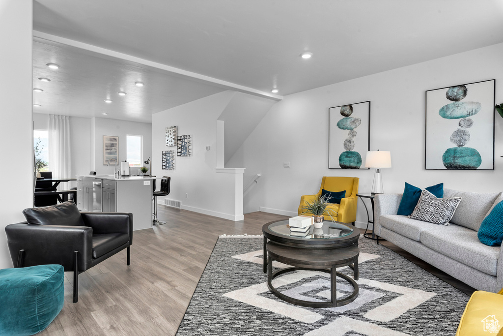 Living room featuring recessed lighting, light wood-type flooring, and baseboards