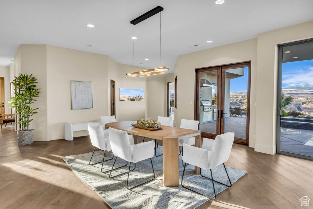 Dining room featuring recessed lighting, french doors, baseboards, and wood finished floors