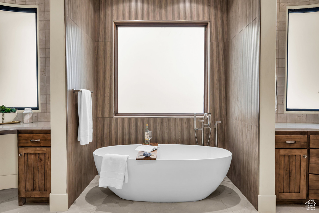 Full bathroom featuring vanity and a freestanding tub