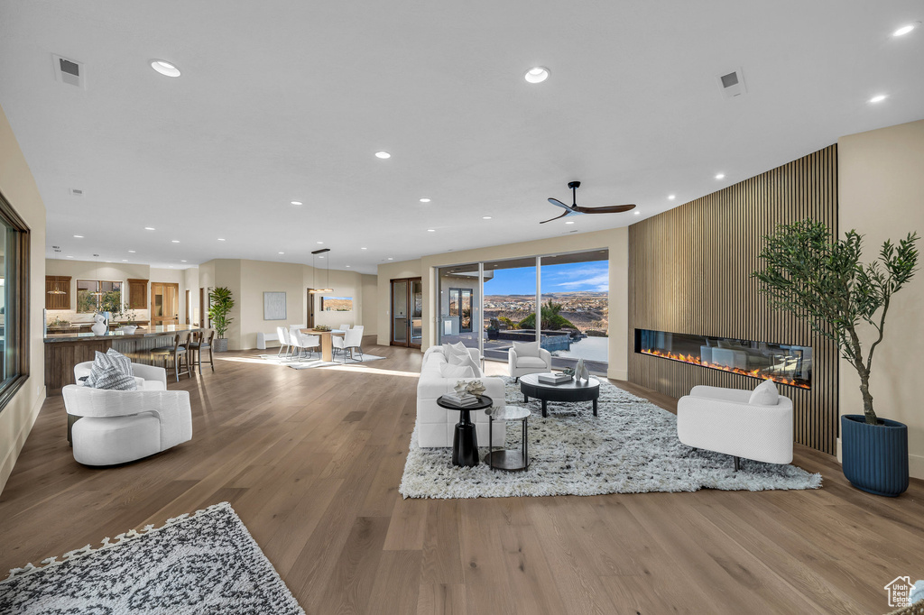 Living area featuring recessed lighting, visible vents, a large fireplace, and wood finished floors