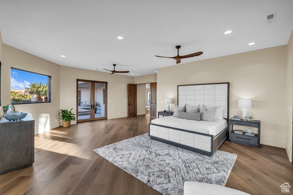 Bedroom featuring dark wood-style floors, recessed lighting, french doors, and access to outside
