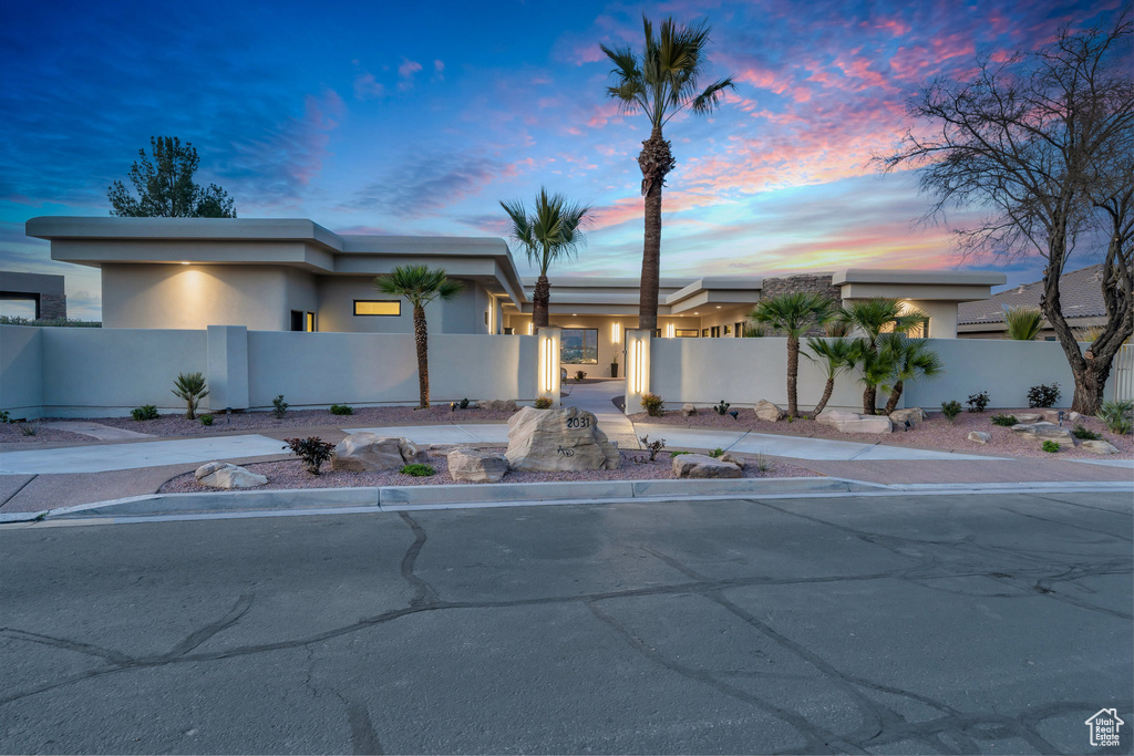 View of front of home featuring a fenced front yard and stucco siding