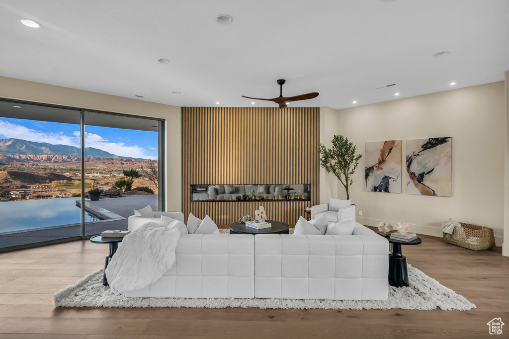 Living area featuring recessed lighting, baseboards, ceiling fan, and wood finished floors