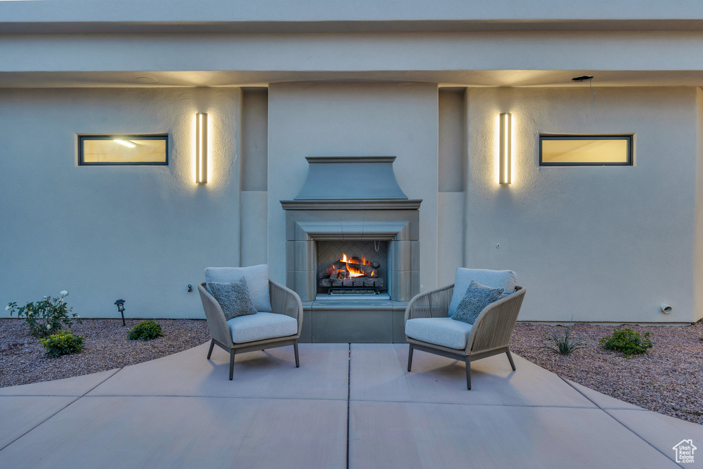 View of patio / terrace with a warm lit fireplace