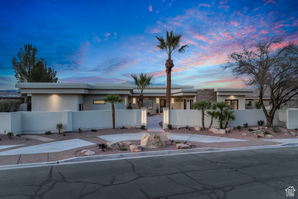 View of front of property featuring a fenced front yard and stucco siding