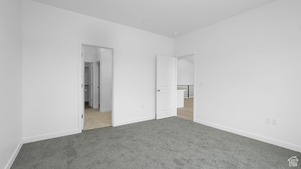 Unfurnished bedroom with carpet floors and baseboards