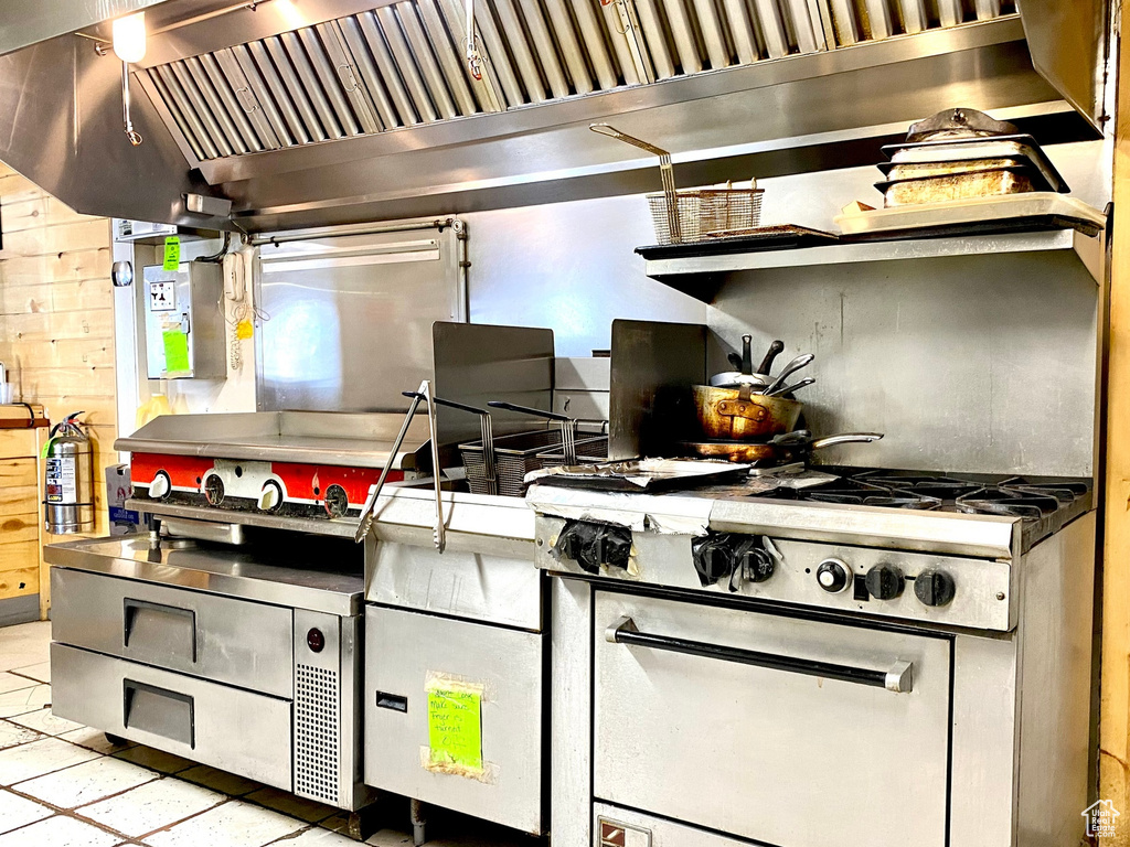Kitchen with gas range and stainless steel countertops