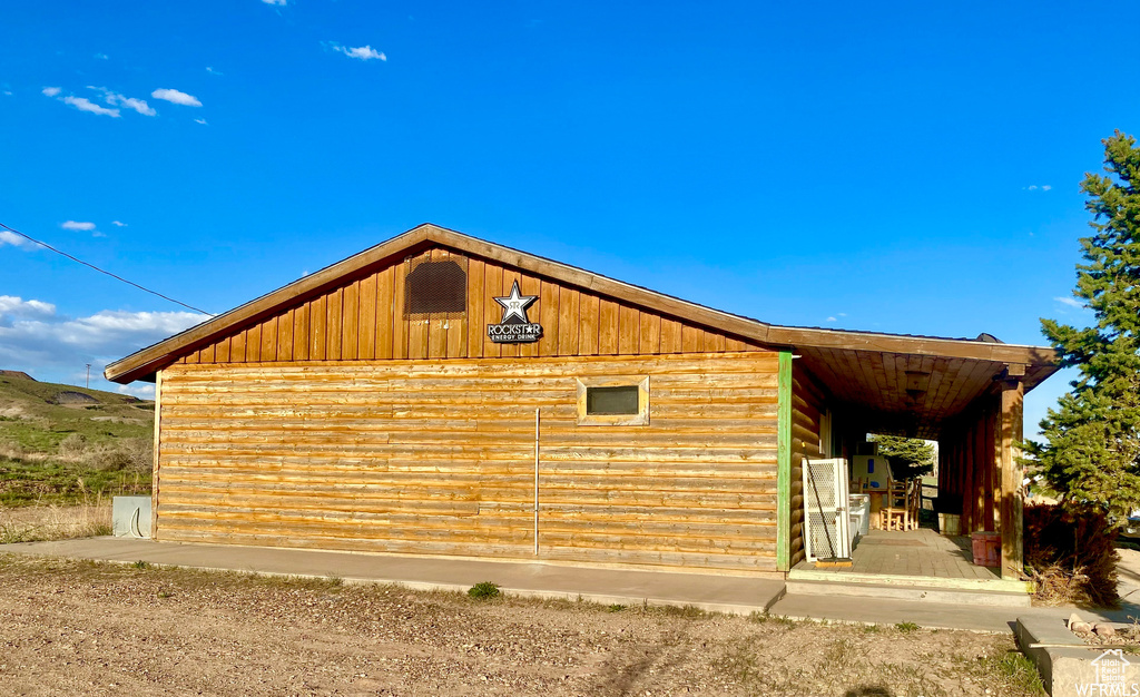 View of home\'s exterior with an outbuilding and a garage