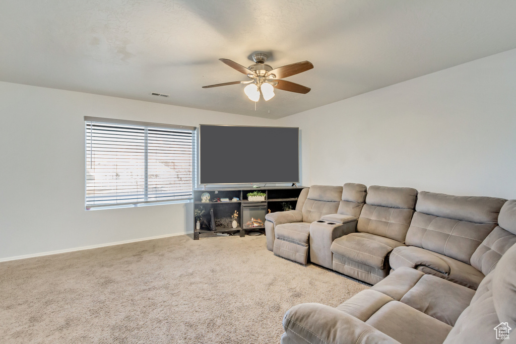 Living area featuring visible vents, baseboards, ceiling fan, and carpet flooring