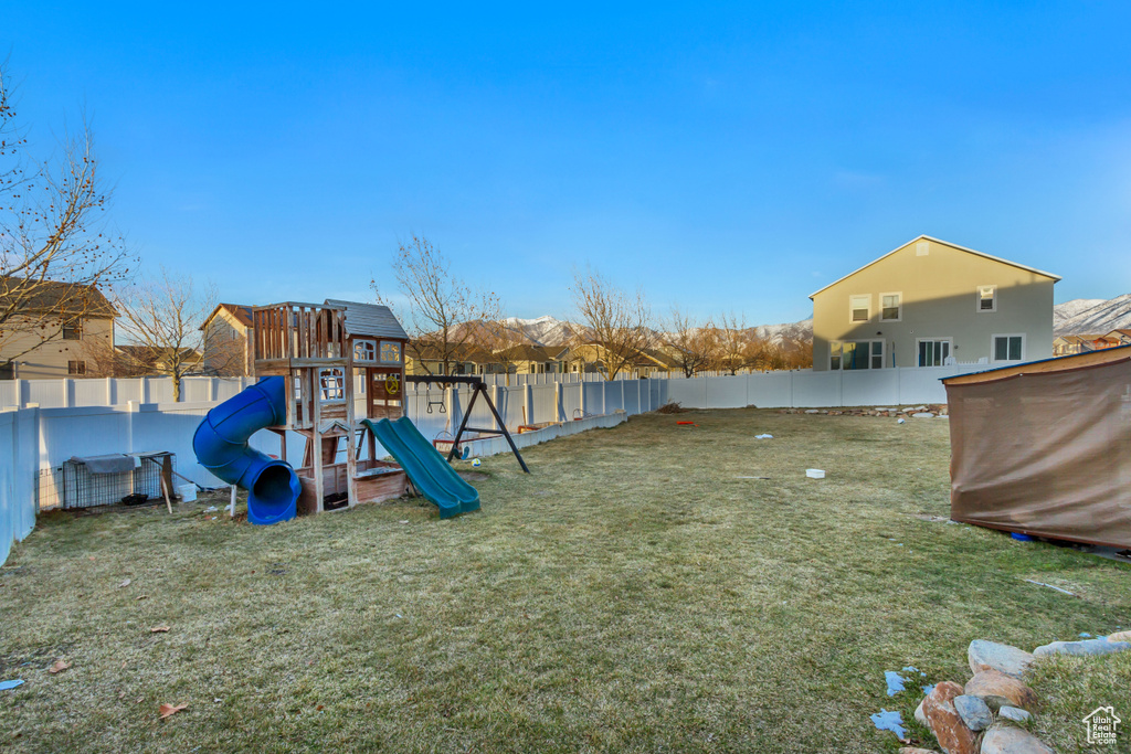 Exterior space featuring a yard and a fenced backyard